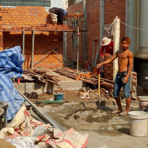 Virak and his brother Sopheap working in construction